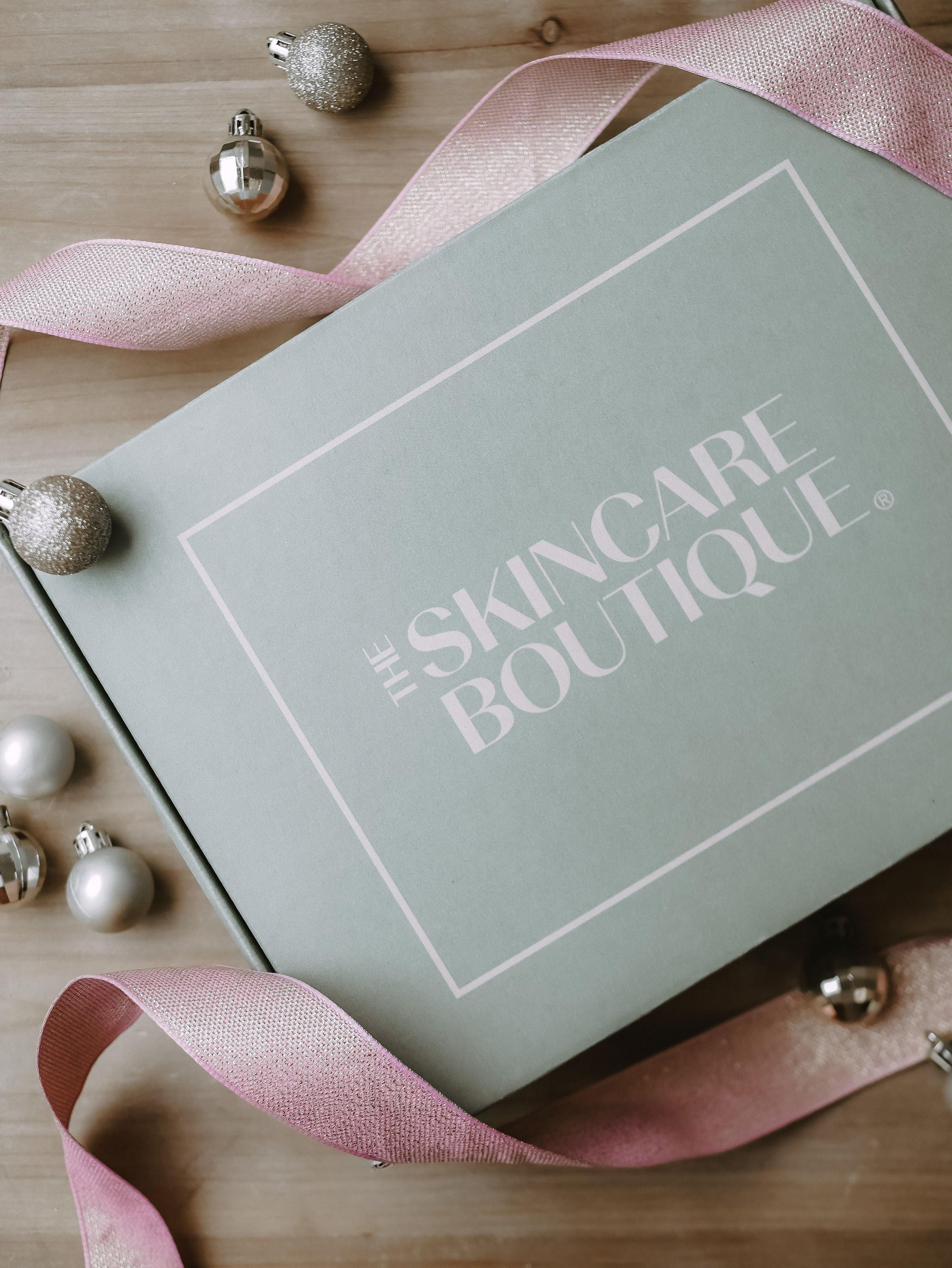 Beautifully wrapped Christmas gifts for inner and outer beauty including skincare, devotionals, and wellness products