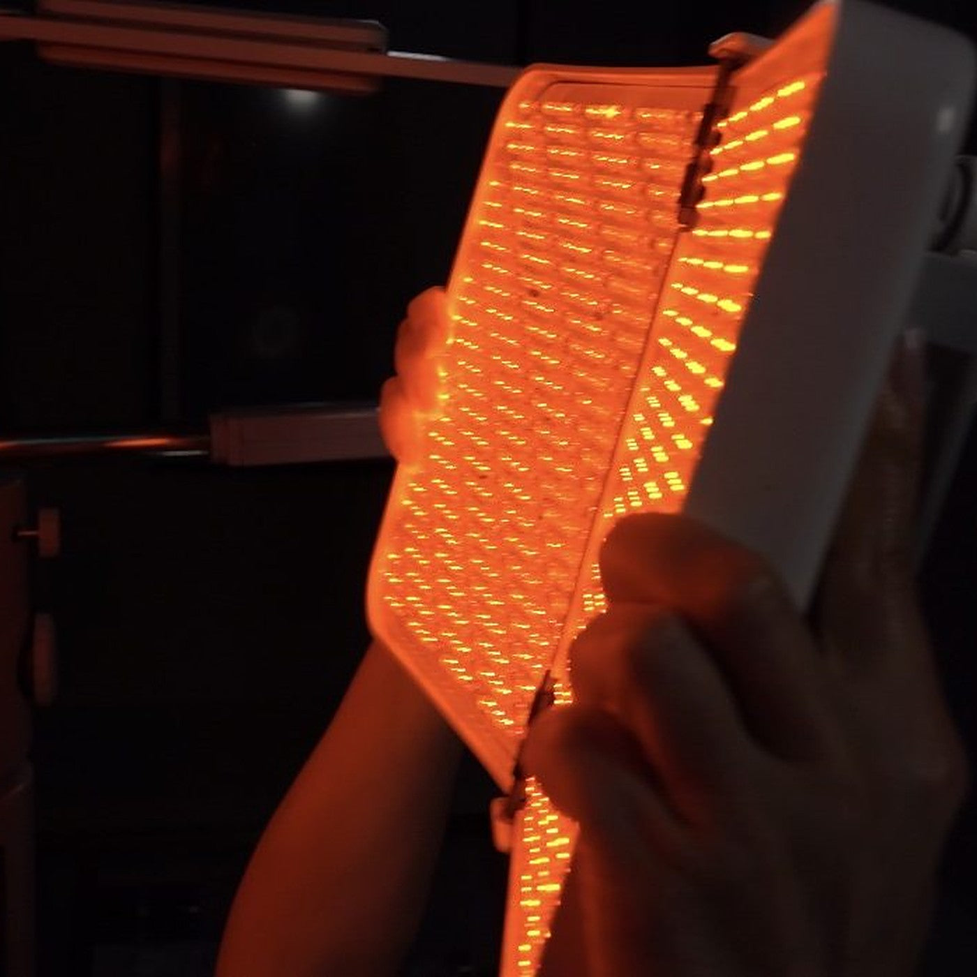 Red LED light therapy panel positioned over a client during a facial treatment at The Skincare Boutique in Ladera Ranch