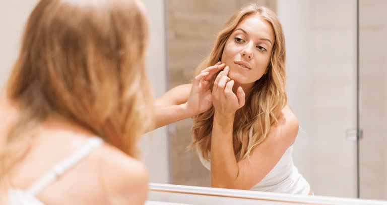 Woman with radiant glowing skin following a medical-grade skincare routine