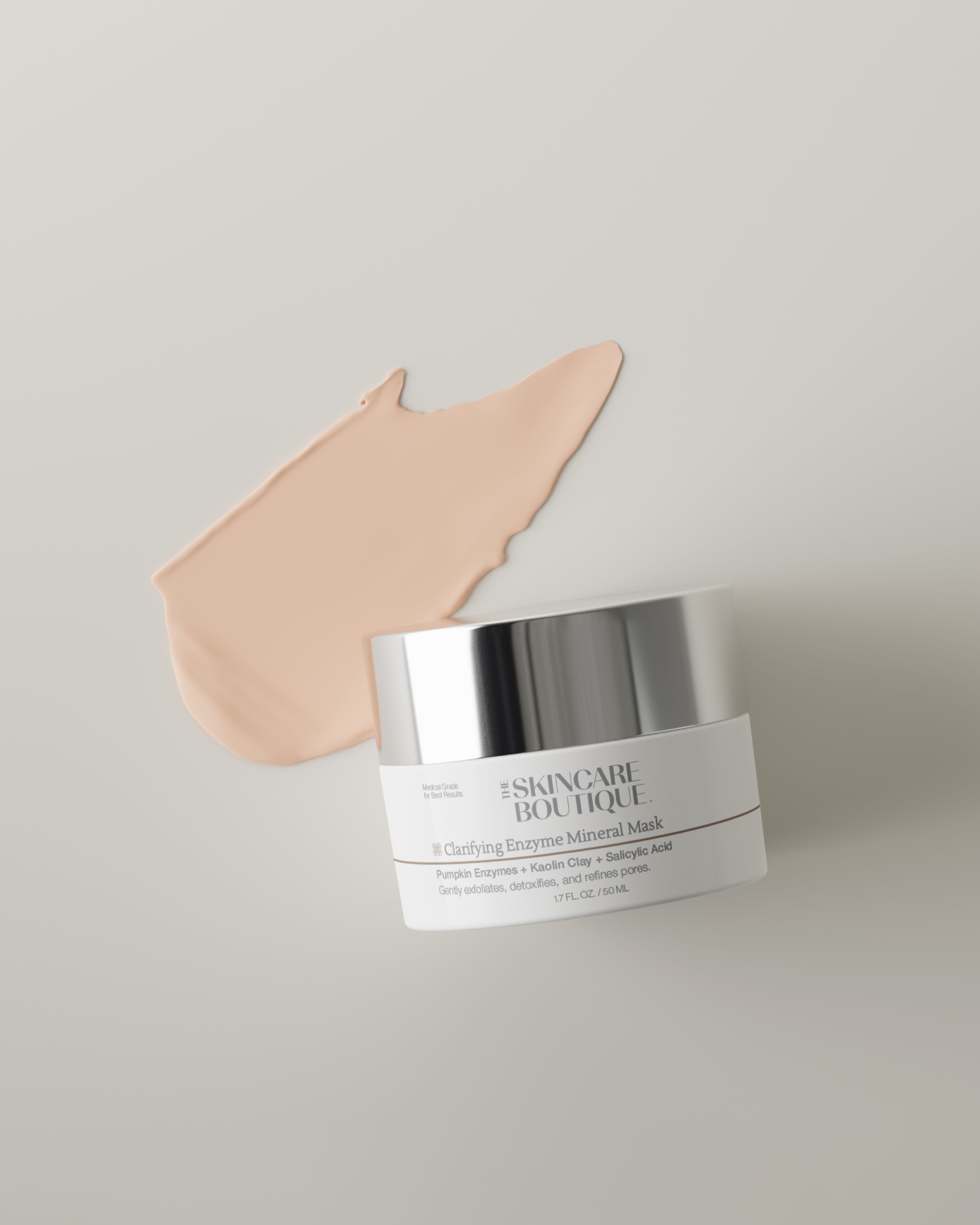 A cosmetic jar labeled 'THE SKINCARE BOUTIQUE' with a peach-colored cream smear behind it on a light gray background.