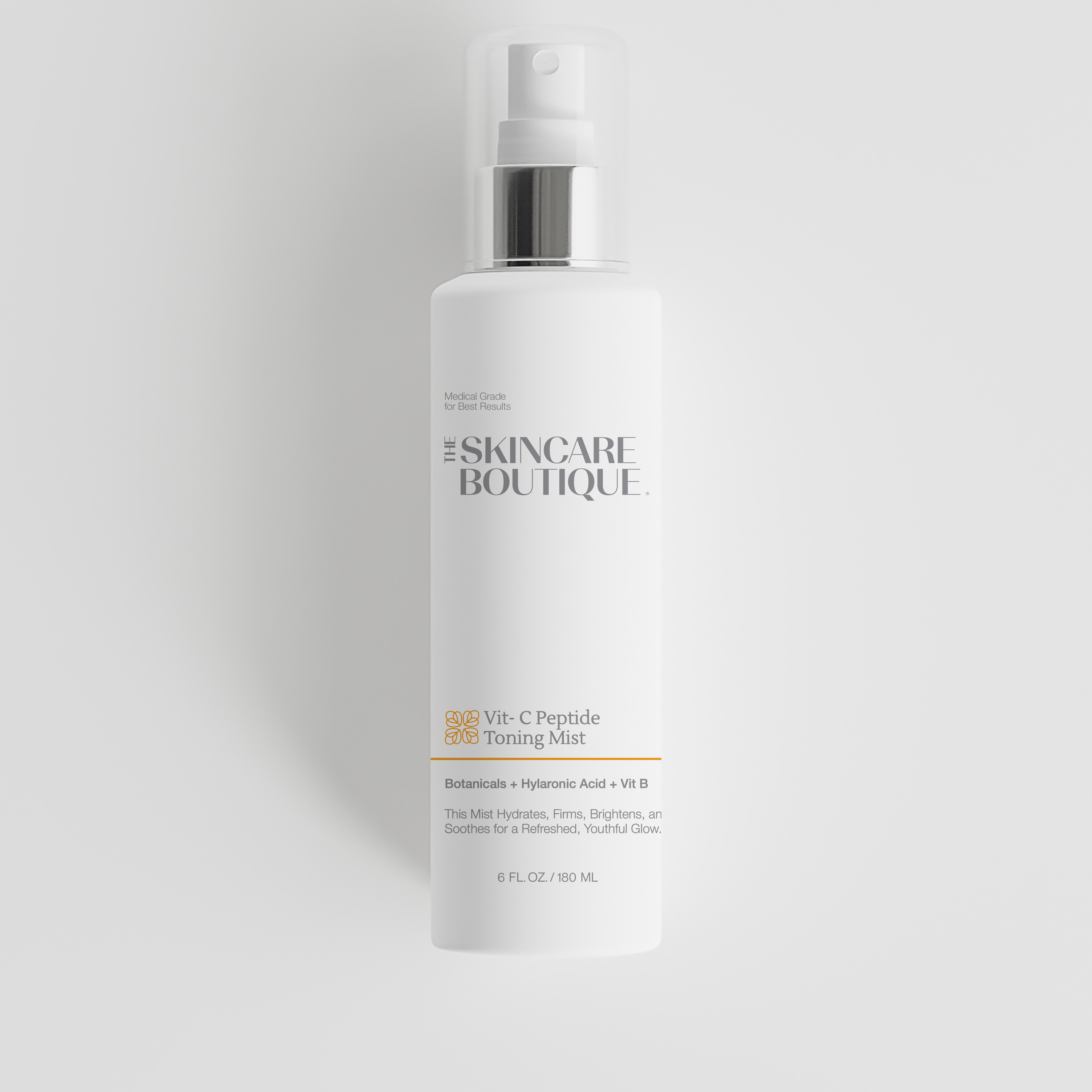 A white skincare bottle with a silver pump dispenser and clear cap, labeled 'The Skincare Boutique' and 'Vit. C Peptide Toning Mist', centered on a light gray background.