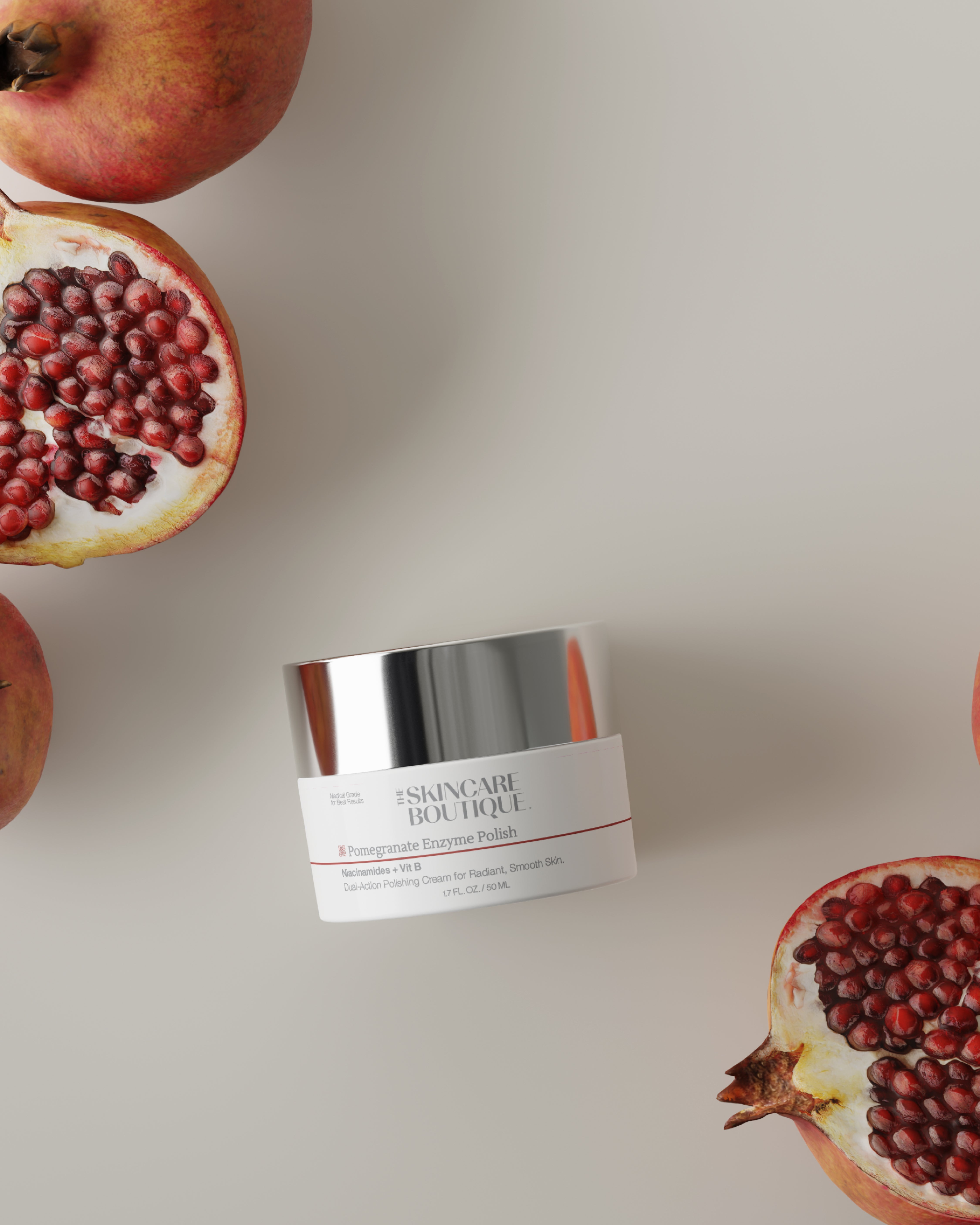Jar of skincare product with pomegranates on a light background