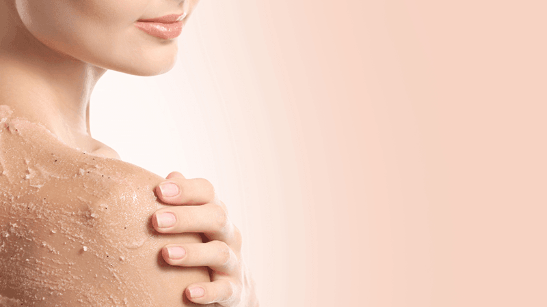 Woman exfoliating skin as part of a medical-grade skincare routine