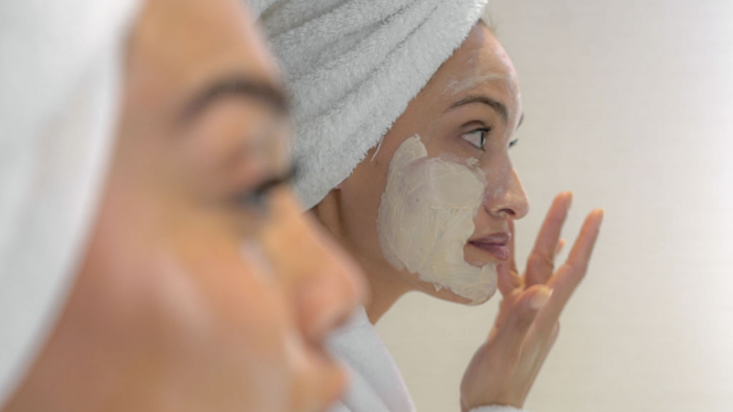 Blog cover image: two girls applying a face mask in the mirror