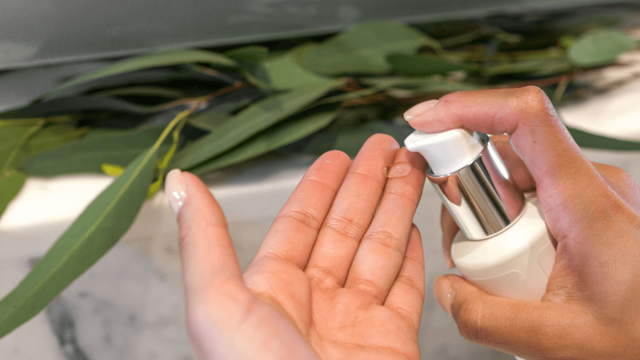 Pumping a TSB serum onto hands with leaves in the background