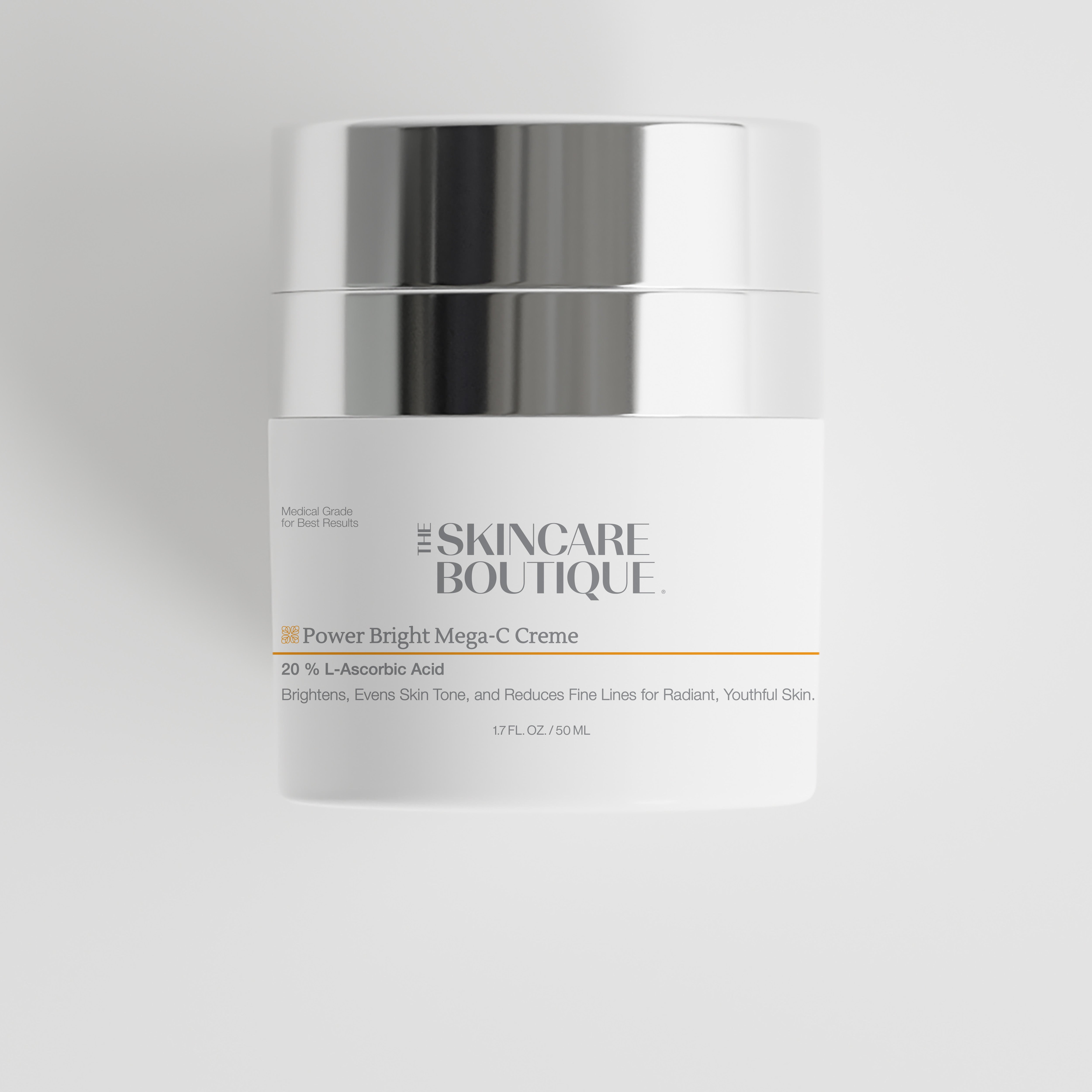 A white cosmetic cream jar with a reflective silver lid, labeled 'The Skincare Boutique Power Bright Mega-C Creme' on a light gray background.