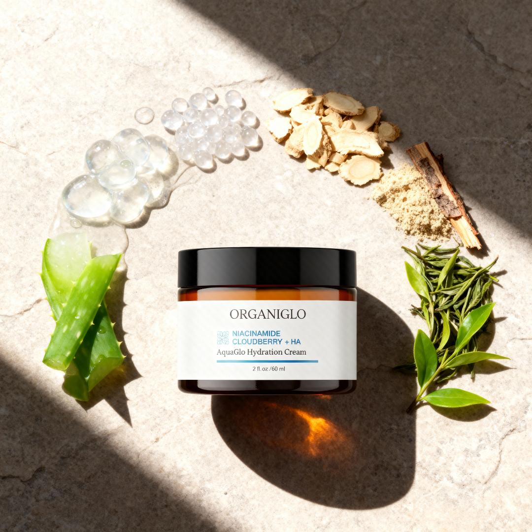 Organiglo skincare cream jar surrounded by natural elements on a textured surface