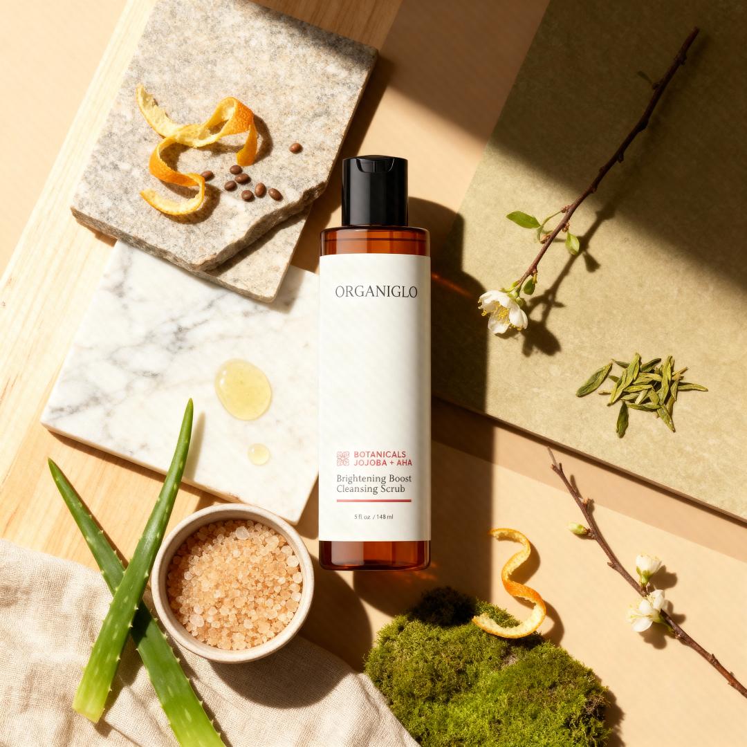 ORGANIGLO cleansing scrub bottle on a natural background with botanical elements