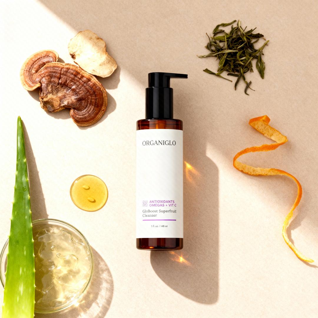 ORGANIGLO skincare product with natural ingredients on a beige background