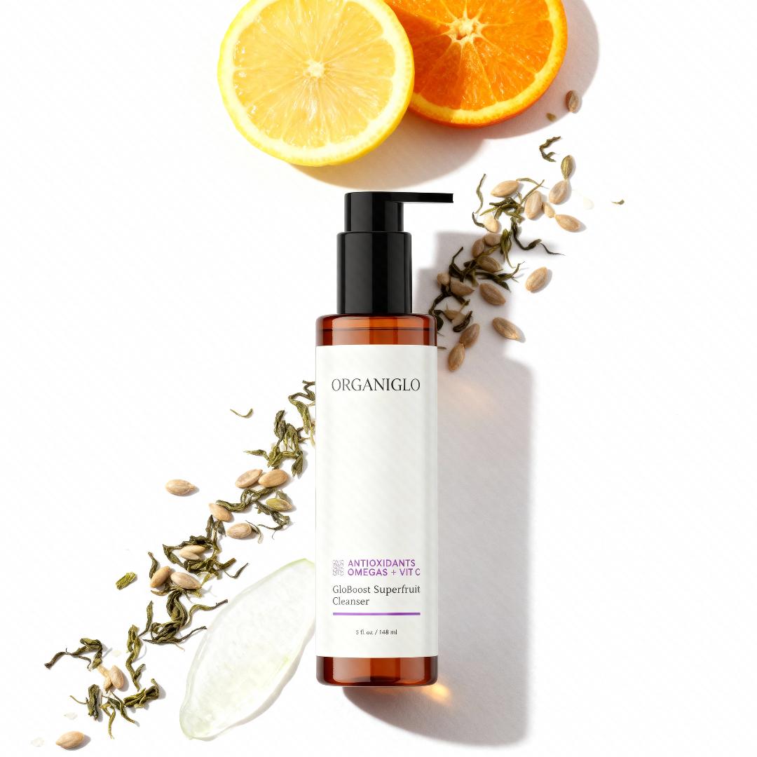 ORGANIGLO skincare product with lemon and orange slices on a white background