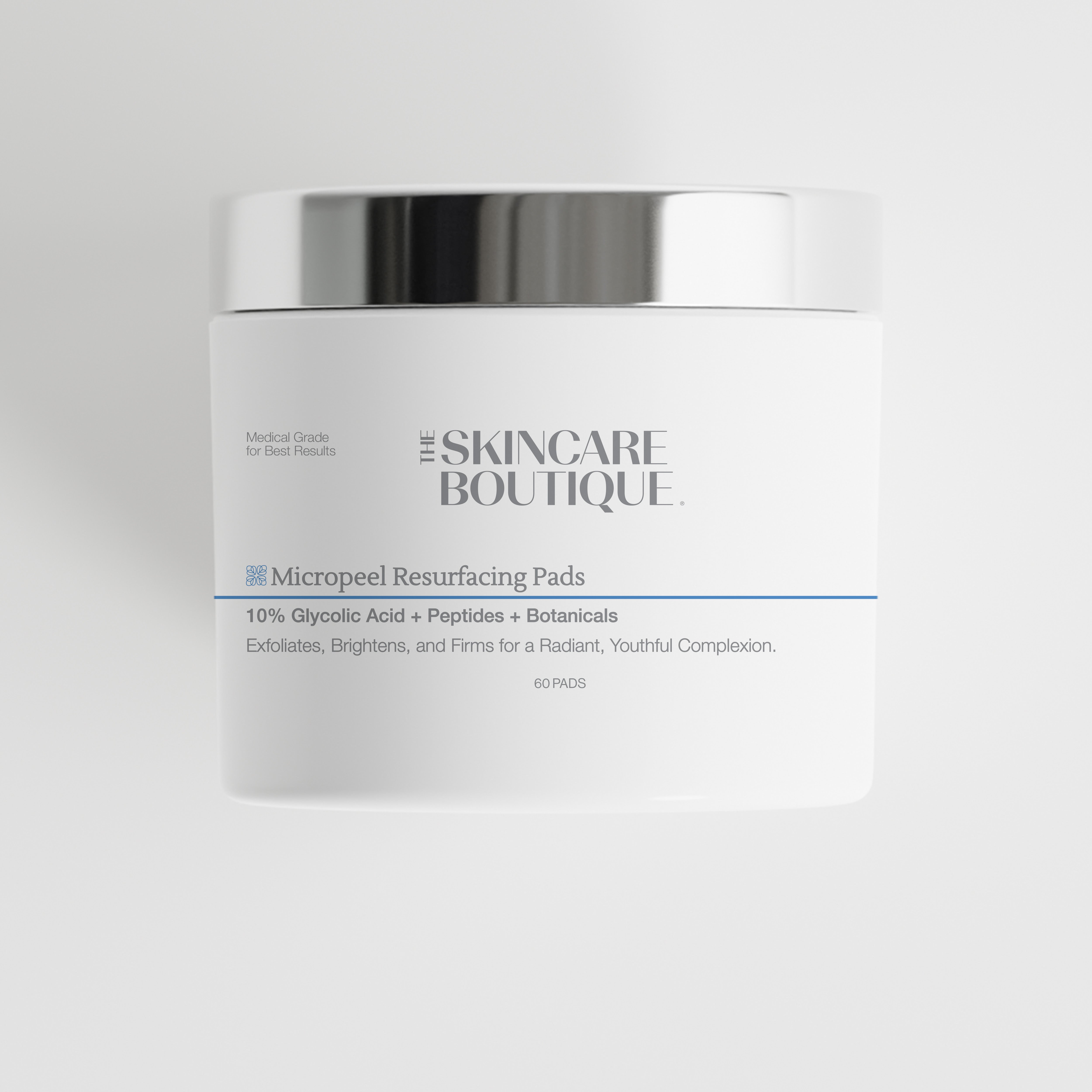 A white cosmetic jar with a reflective silver lid from The Skincare Boutique, labeled 'Micropeel Resurfacing Pads' on a light gray background.