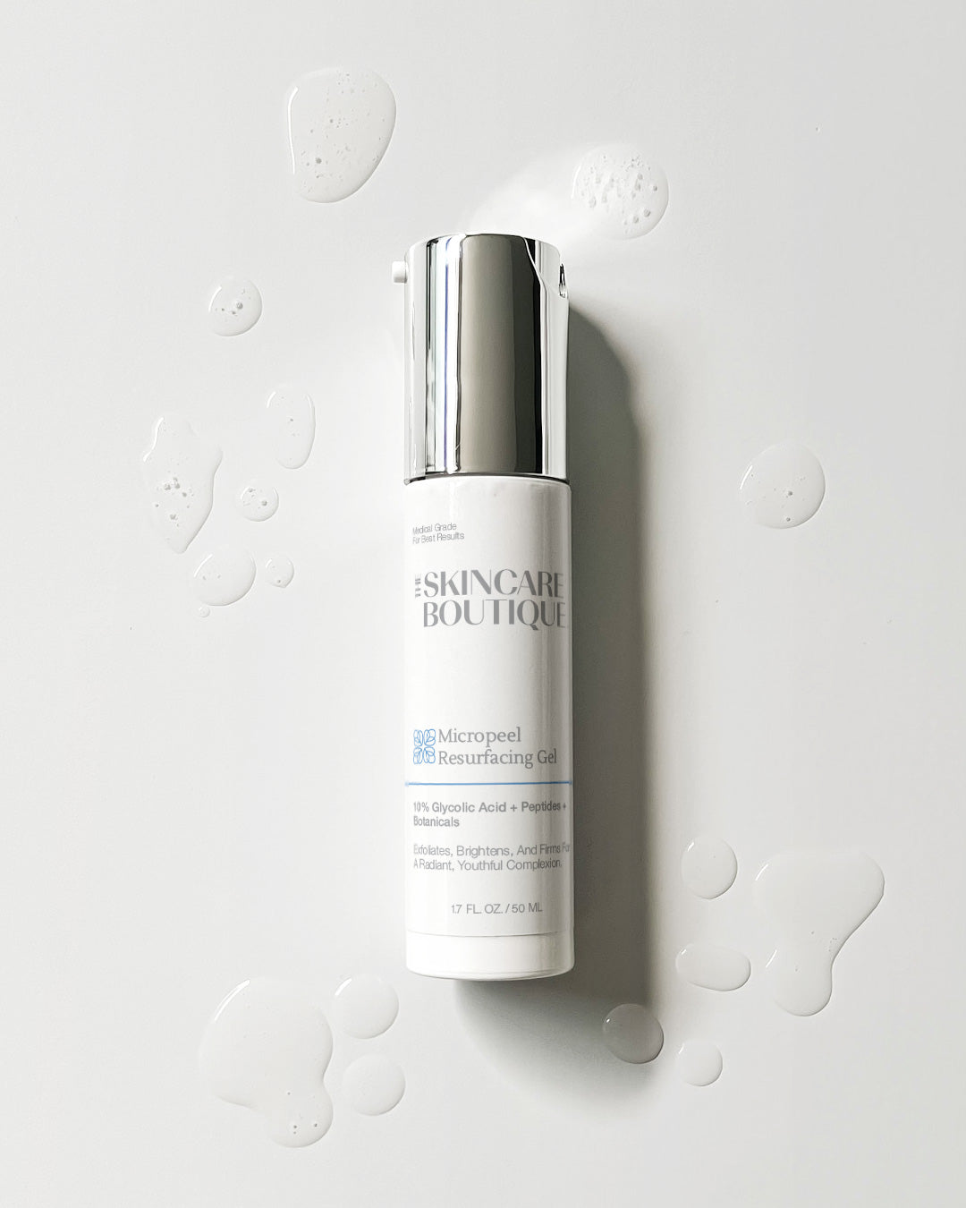 Skincare bottle labeled 'Skincare Boutique' on a light gray background with water droplets.