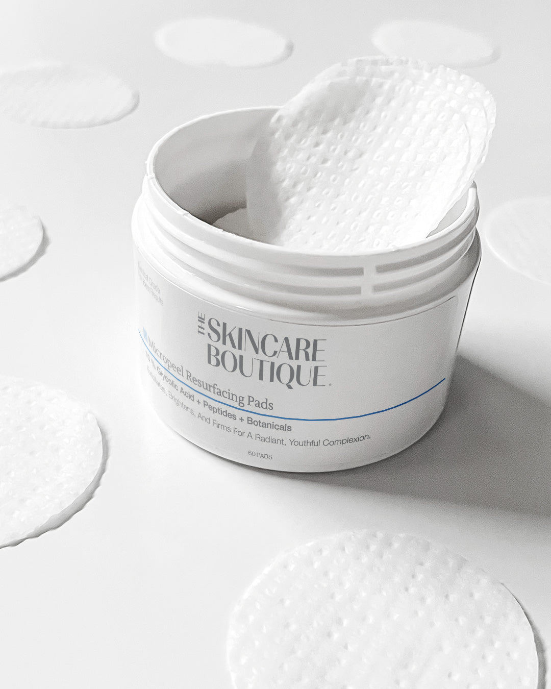 Jar of skincare pads with a white background
