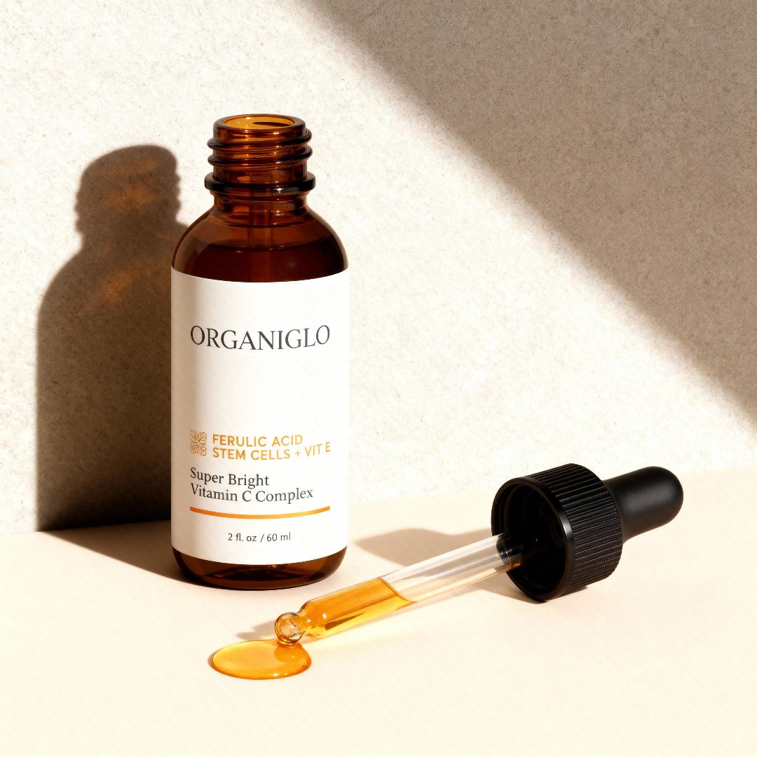 Organiglo skincare serum bottle with dropper on a light background