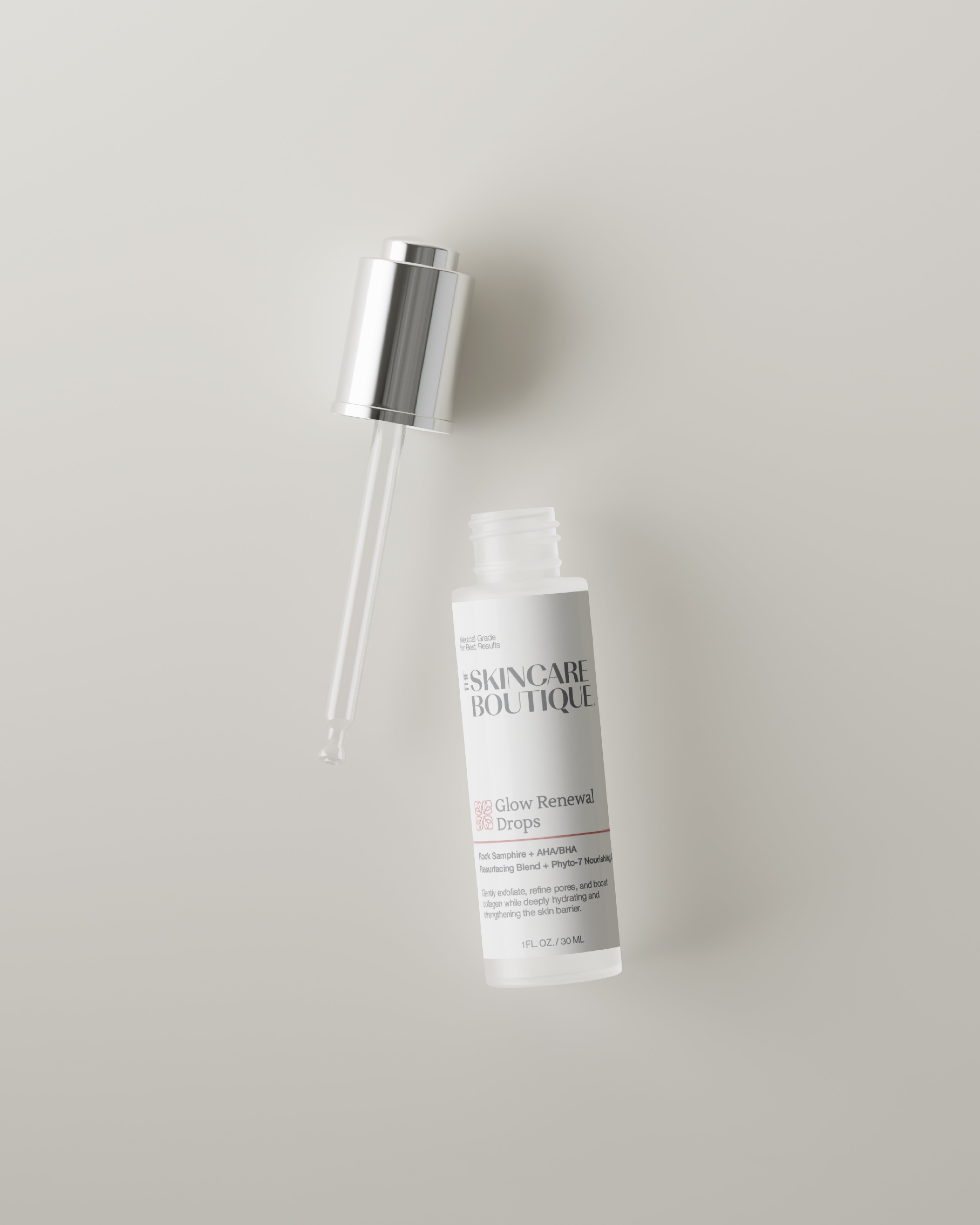 Skincare bottle with dropper on a light gray background